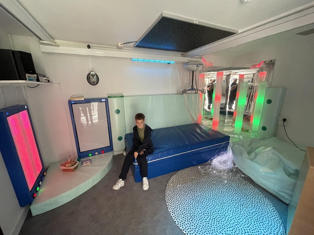 Dexter sitting on the padded mat in the hospice sensory room