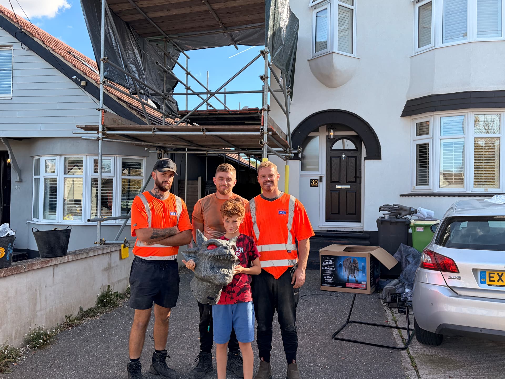 Dexter with the TG Scaffolding team and the gargoyle outside 30 Queens Road