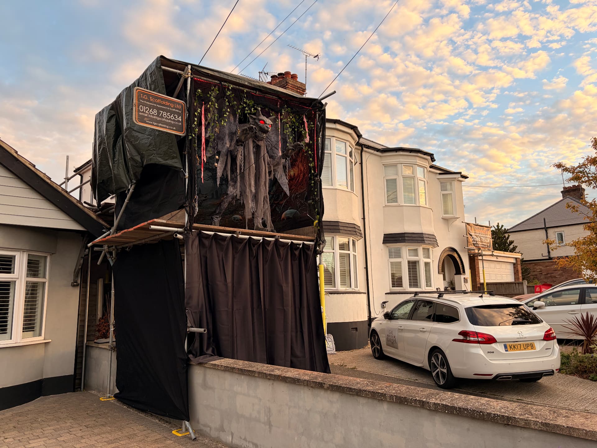 The gargoyle display outside Queens Road as the evening sky turns golden