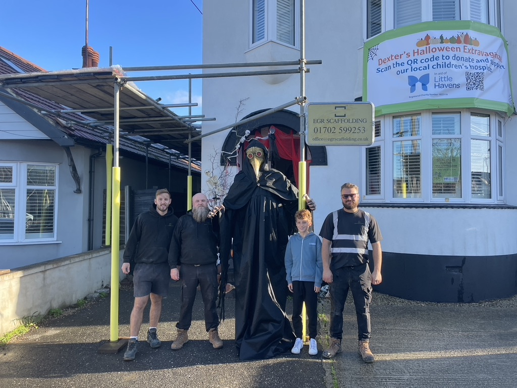 Dexter and the scaffolding crew with our plague doctor outside the house